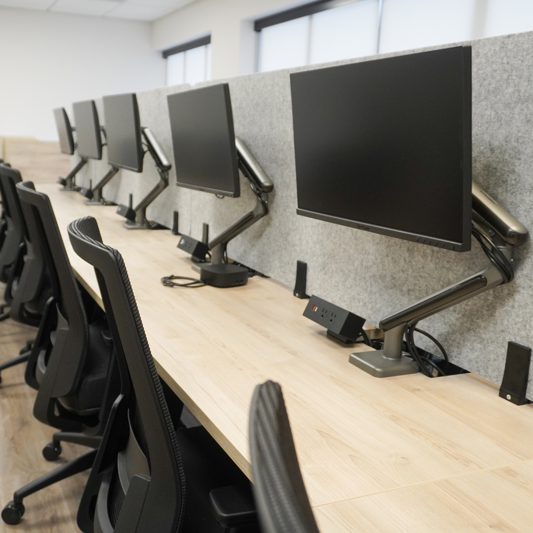 Multiple space efficient touchdown workspaces maximizing the use of space while maintaining room volume and comfort.