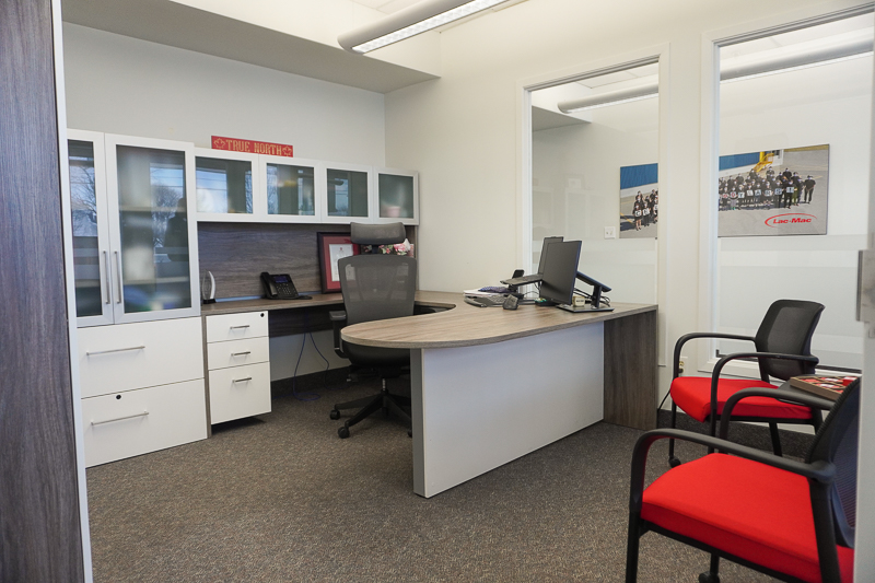Inviting private office incorporating Canadian heritage and bold brand colours